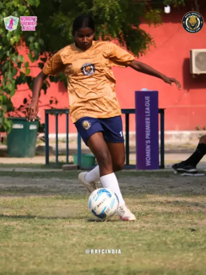 Our player skillfully dribbling the ball, demonstrating close control and balance during a match.