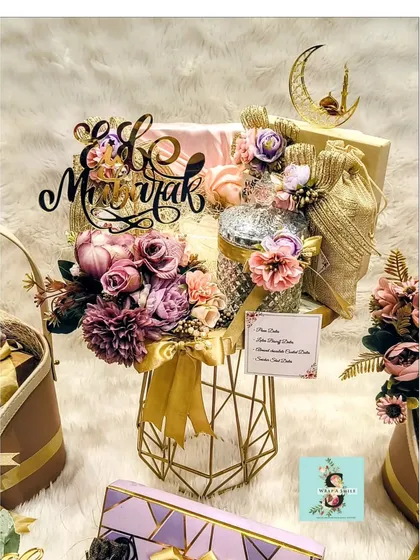 A close-up of the elegant Eid hamper I designed, featuring a geometric gold vase, intricate floral arrangements, and an "Eid Mubarak" topper. This gift was part of a special curation for the Nadiadwala family.