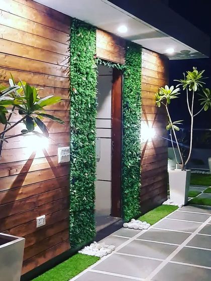 A beautiful wall decor solution combining natural pinewood cladding with strips of vertical garden panels for a modern, textured look.