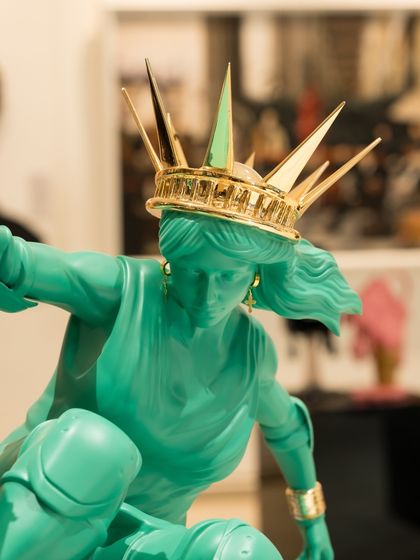 A close-up of Lady Liberty's face and crown, her expression focused and determined as she navigates her new path.