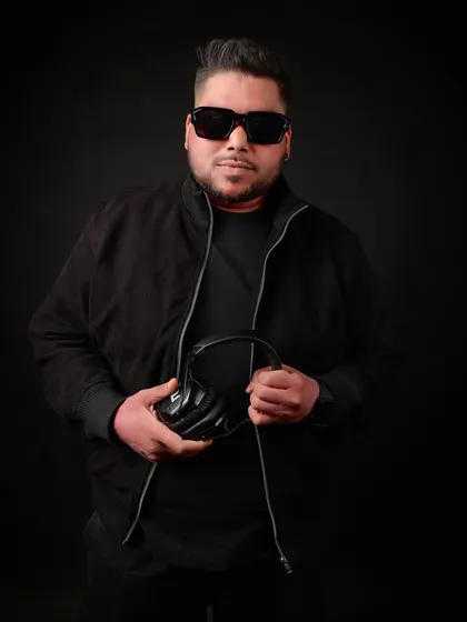 Holding my most important tool: the headphones. This is where the music begins.