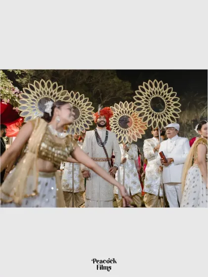 The groom's grand entrance (baraat), with dancers celebrating his arrival. A vibrant and energetic start to the wedding ceremony.