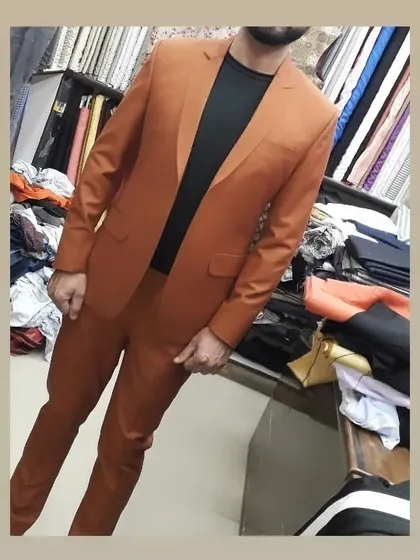 A burnt orange two piece suit tailored for a client. This is a great example of a smart casual suit that can be worn with a t-shirt for a relaxed yet stylish look.
