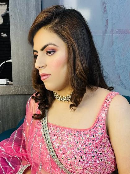 A light party makeup look featuring soft pink eyeshadow and a matching lip. This is a great option for daytime events or for those who prefer a more subtle enhancement.