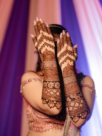 A full-coverage design with repeating geometric and floral bands, creating a rich and textured look that extends from the fingers to the mid-forearm.