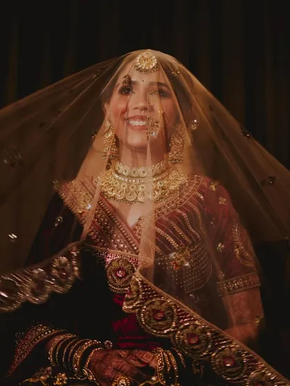 A joyful shot of the bride under her veil. Her smile is infectious, and her makeup looks flawless.