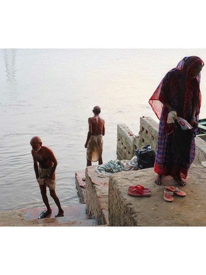 A layered composition on the banks of the Yamuna, showing people preparing for a morning dip. The different figures create a sense of depth and narrative.