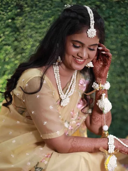Another joyful shot from the Haldi function. The focus was on fresh, dewy skin and a simple hairstyle, perfect for the occasion.