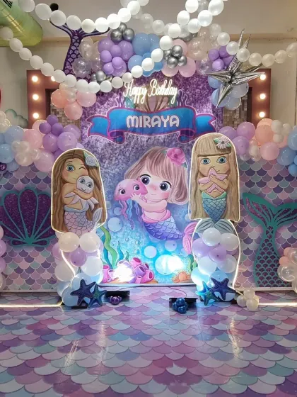 A wider view of the enchanting Mermaid party. The pastel balloon garlands and light-up marquee frame create a beautiful photo opportunity and a truly immersive under-the-sea experience.