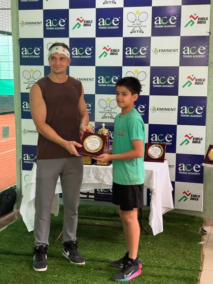 An adult player presenting an award to one of our junior champions, bridging the gap between generations of players.