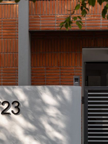 A detail of the Baliapatanam brickwork on the facade of Project 723. The soldier and stretcher bonds create a unique linear pattern that adds visual interest and texture.