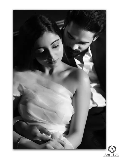 An intimate and sensual black and white close-up. The soft focus and tight framing create a deeply personal and romantic mood, highlighting the trust and affection between the couple.