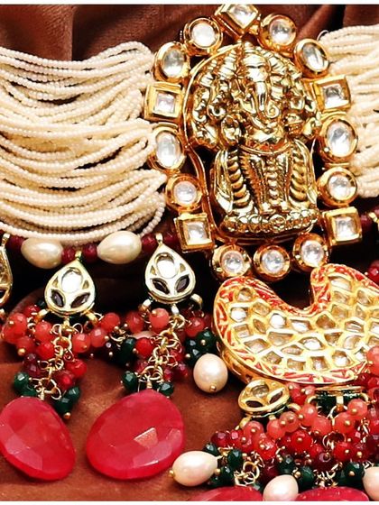 A close-up of our intricately crafted temple jewellery, showcasing the detailed Ganesha motif and the vibrant red stones.