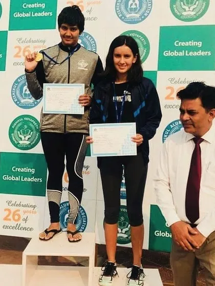 Kritika Mann stands on the podium after winning a national medal against swimmers from international training hubs in Australia and Phuket. This proves my coaching methods create athletes who can compete and win on any stage.