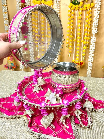 A closer look at the intricate work on our pink 'CHAAND' thali. The delicate floral hangings and gota patti work make it a standout piece.