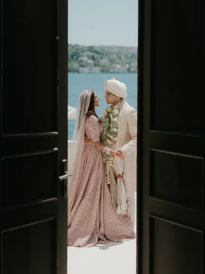 A stolen glance through a doorway in Turkey. This composition uses natural framing to create a sense of privacy and intimacy, as the couple shares a moment by the water, away from the world. It’s a quiet, observational style of destination wedding photography.