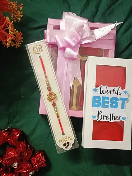A "World's Best Brother" gift set, including a personalized chocolate box, a rakhi, and extra chocolates.