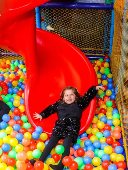 This is what pure joy looks like. My indoor play zone is designed for endless fun, with features like this spiral slide that ends in a sea of colorful balls, ensuring your kids have an absolute blast.