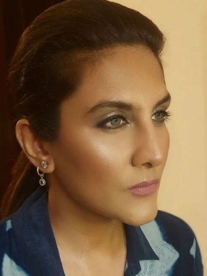 A profile view that captures the stunning color of the client's eyes, enhanced by a soft smokey liner and well-defined brows.