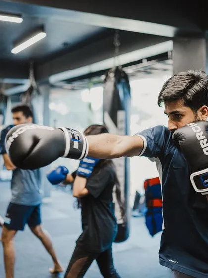 Students in a line practice their punches, building muscle memory through repetition.