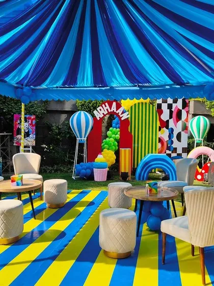 An abstract-themed lounge area with bold striped flooring and a colorful canopy.