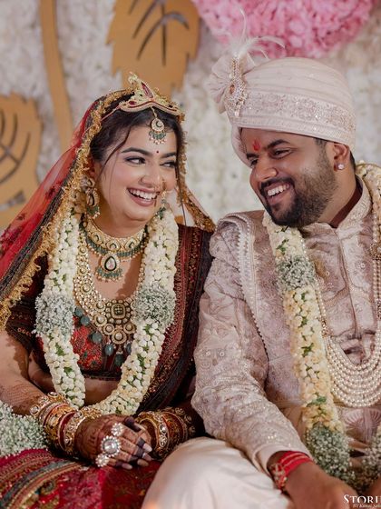 A heartwarming, candid shot of the couple laughing together during their wedding ceremony.