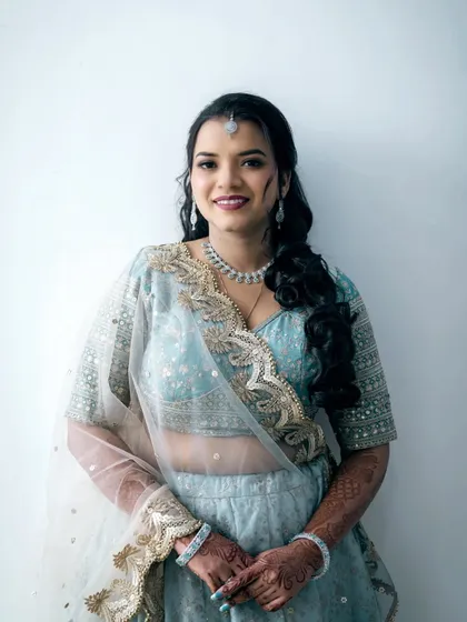 A lovely portrait of the bride-to-be, showcasing her elegant light blue lehenga and diamond jewelry.