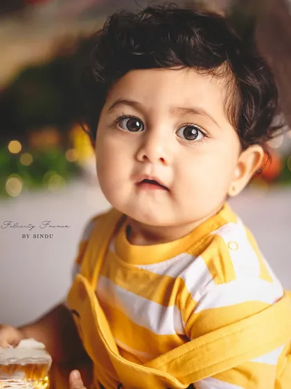 A close-up of this adorable baby boy in his Winnie the Pooh outfit. His curious expression is just priceless.