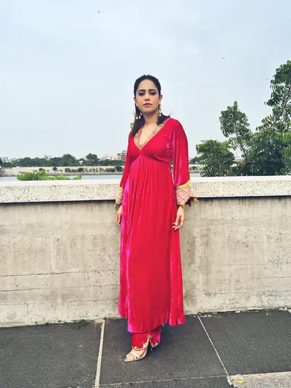 A pop of pink for Nushrratt Bharuccha in Ahmedabad. This velvet maxi dress with embellished cuffs is a comfortable yet glamorous choice for travel and promotional events.
