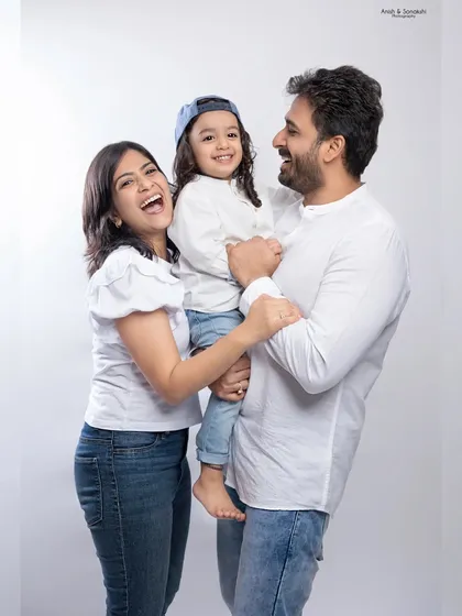 Love, laughter, and happiness. This candid family portrait captures a genuine moment of joy and connection.