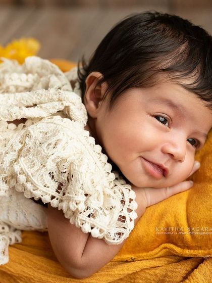 A one-month-old baby girl with a sweet, knowing smile. Her personality is already starting to emerge in this beautiful, simple portrait.