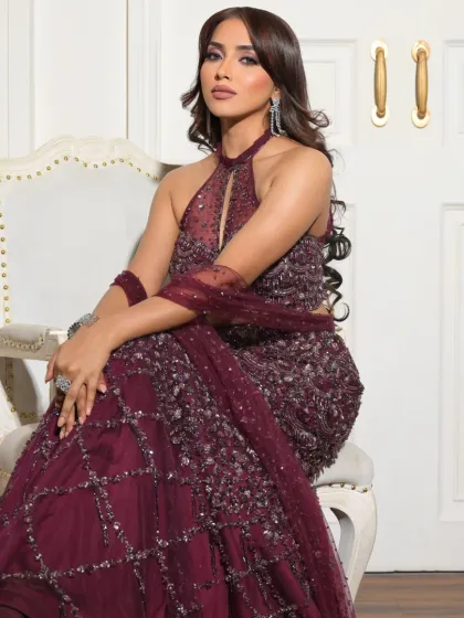 Seated gracefully, this shot shows the full effect of the glamorous look. The makeup is designed to be photo-ready and stunning from every angle.