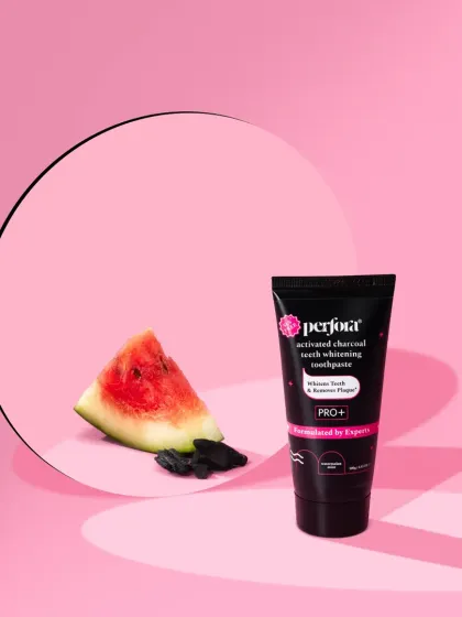 For this charcoal whitening toothpaste, we used a round mirror to reflect a slice of watermelon and charcoal pieces. The pink background provides a surprising and pleasant contrast to the black product tube.