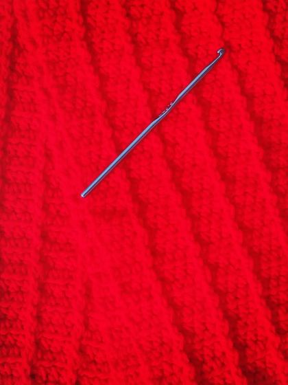 The magic in progress. The yarn is slowly turning into a beautifully textured fabric with a ribbed pattern.