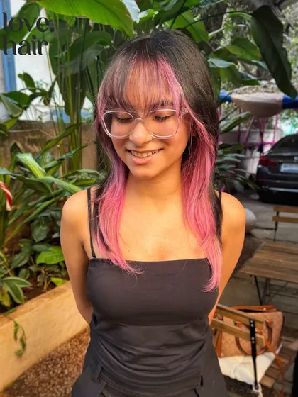 This look is just GIVING. A bold, pink money piece and face-framing layers make for a trendy and fun style. We used bleach to get that bright candy pink.