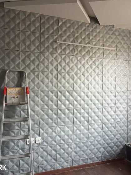 An installation of 3D foam panels in a geometric diamond pattern. These panels add significant depth and a modern, tactile finish to the wall, ideal for a contemporary home.