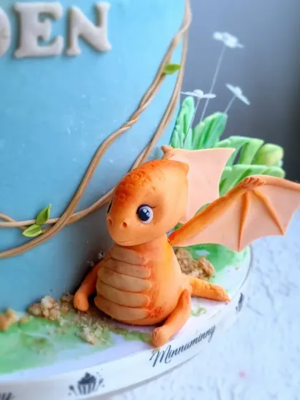 A detailed shot of the cute, winged dragon topper from the dinosaur cake.