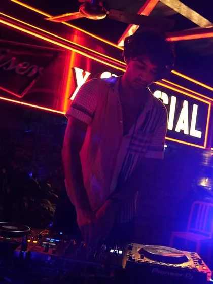 A DJ at the decks during our Social Sunday Sundowner, providing the beats for an unforgettable night.