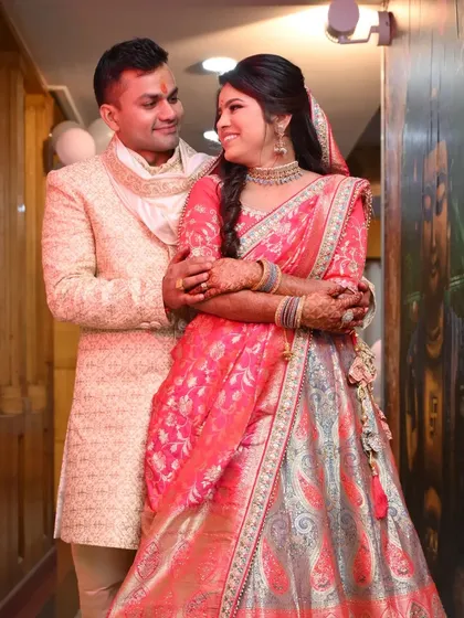 A sweet and happy portrait of a newly engaged couple, sharing a look of love and excitement.