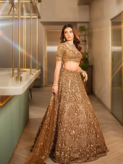 Hollywood waves for a glamorous reception or cocktail look. This style exudes sophistication and pairs beautifully with a heavily embellished lehenga.