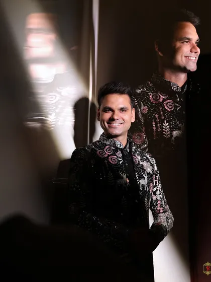 An artistic portrait of the groom using shadows and light to create a dramatic and thoughtful image.