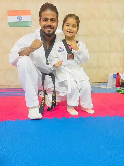 A proud moment with one of our youngest Taekwondo kids. She has earned her medal and stands ready for the next challenge.