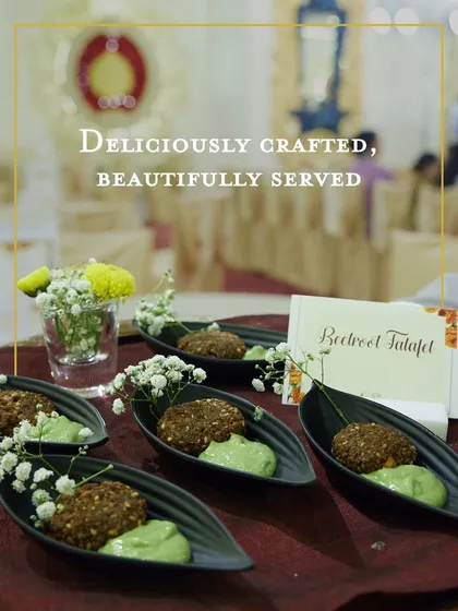 Beetroot Falafel served with a vibrant green parsley hummus. This colourful and healthy appetizer is both delicious and visually appealing, garnished with delicate baby's breath flowers.