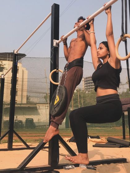 Stronger together. This couple pushes each other to new heights with partner-assisted and weighted workouts.