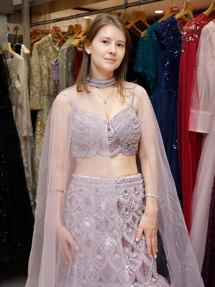 Here is a stunning client in a fish-cut designer lehenga in a beautiful pastel shade. Renting allows you to wear high-fashion styles like this.