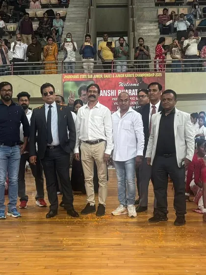 Standing with officials and young athletes at the Jharkhand championship. It is important for the youth to see the leadership's commitment to the sport.