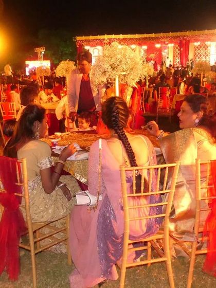A wide shot of the outdoor seating area at a grand wedding. I can arrange catering for both indoor and outdoor venues, adapting the setup to the environment.