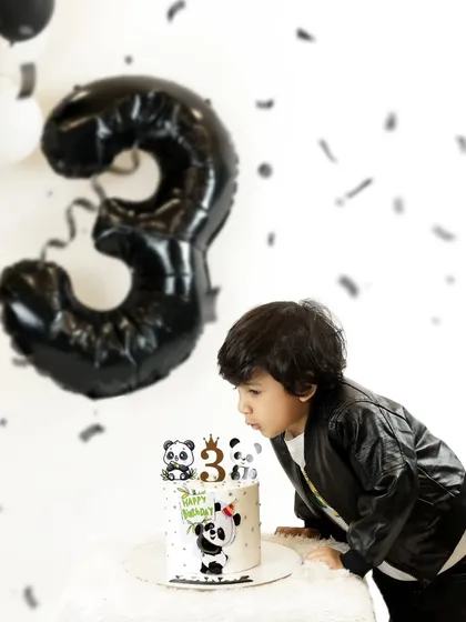 A "then and now" moment. This cool three-year-old is blowing out his birthday candles, and we love looking back at his newborn photos to see how much he has grown.