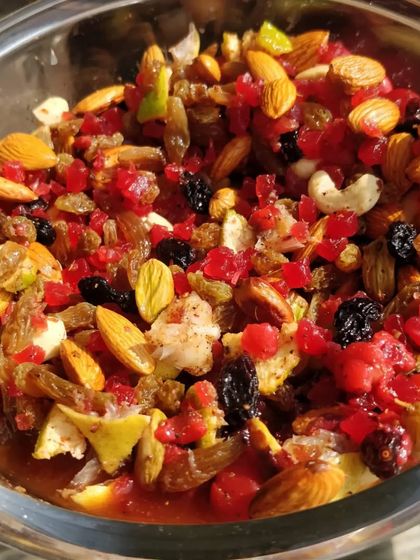 A close up of our Christmas fruit mix after soaking. This colorful and aromatic blend of nuts, berries, and candied fruits is what gives our rum and plum cakes their signature taste.