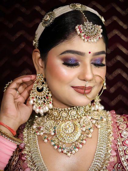 A student's work from a makeup academy, featuring one of my heavy bridal lehengas and a unique pink and purple jewellery set.